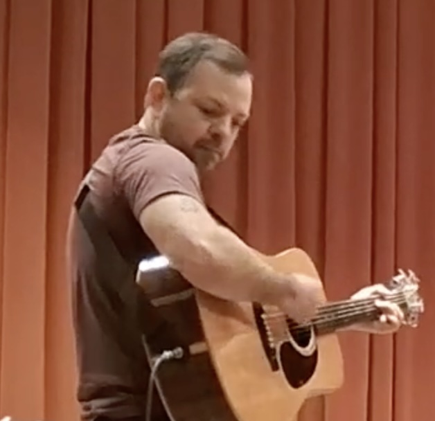 Charley Beller playing guitar